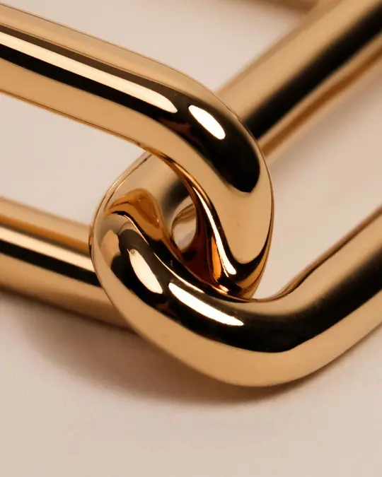 Two interlocking polished gold chain links